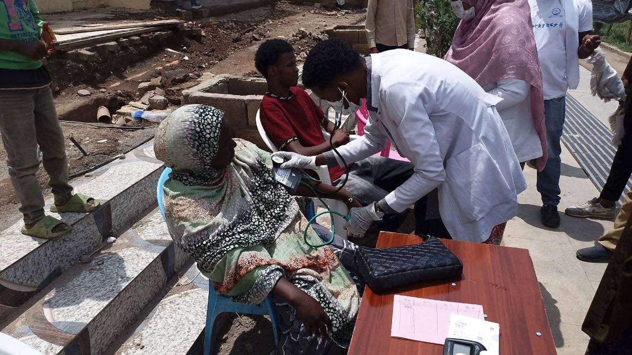 A SHIFA clinician checking a community member's blood pressure during a free health screening